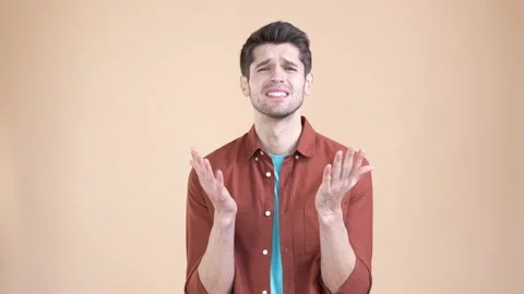 Desperate guy problem plead hands worry isolated pastel color background Stock Footage 169938008