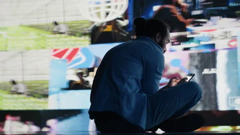 Desperate guy staring at phone screen in misery symbolizing toxic social media Video stock 311135710
