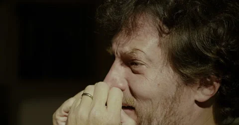 Desperate man crying at home at night closeup Stock Footage 63447817