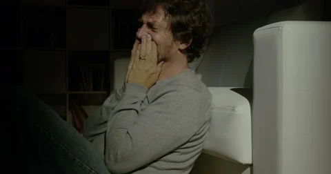 Desperate man crying at home at night Stock Footage 63453533