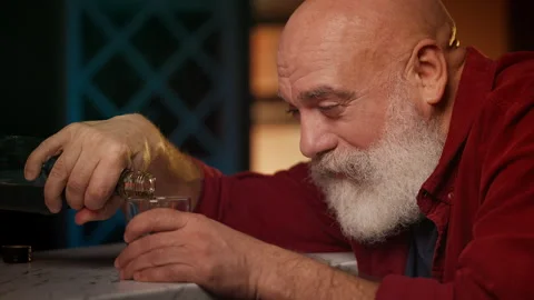 Desperate man in his 50s pours alcohol into glass, coping with problems Stock Footage 346714152