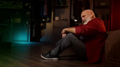 Desperate man in his 50s reflects on life problems while sitting on the floor Stock Footage 342520532