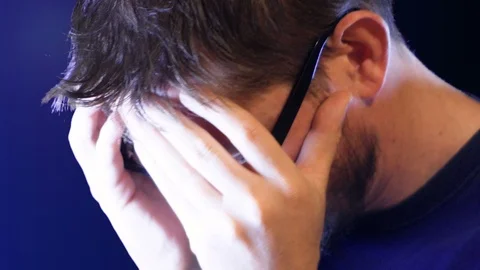 Desperate man with his face in his hands, detail, footage represents feelings Stock Footage 101235206