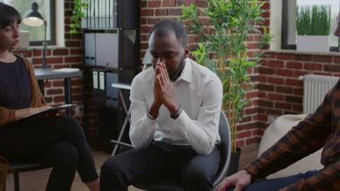 Desperate man making confession in front of people with addiction at aa support Stock Footage 165154380