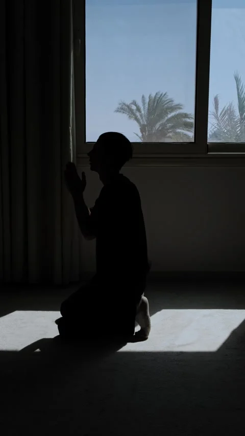 Desperate man praying on his knees in dark silhouette, seeking divine help Stock Footage 346248458