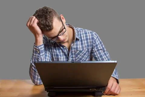 Desperate man sitting at the computer Stock Photos