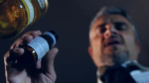 Desperate man taking pills drinking alcohol Stock Footage 50672851