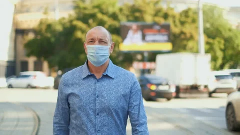 Desperate mask old human walk along empty road. Man Covid-19. Coronavirus people Stock Footage 137532636