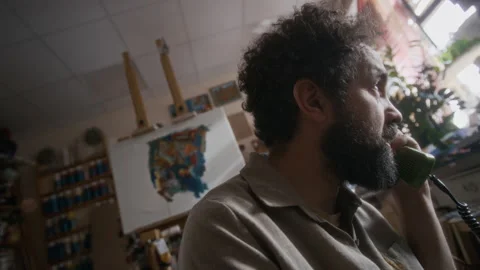 Desperate Painter Feeling Hopeless after Difficult Phone Conversation in Studio Stock Footage 334681879
