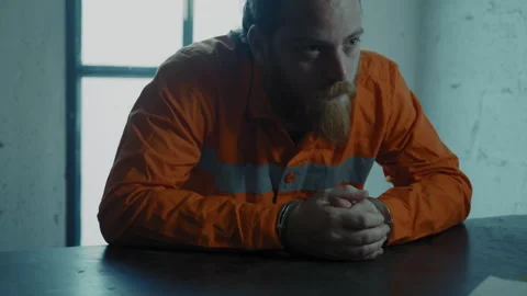 Desperate prisoner in a small dark interrogation room Stock Footage 275029602