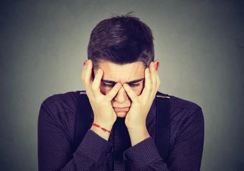 Desperate sad man crying in his hands Stock Photos