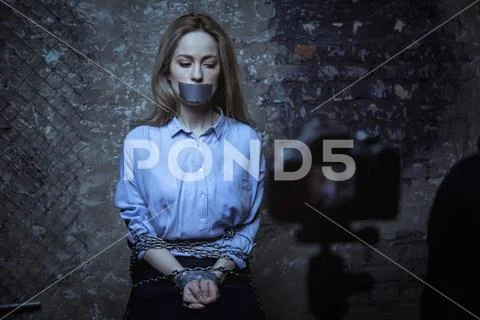 Desperate scared woman posing for a ransom Stock Photos