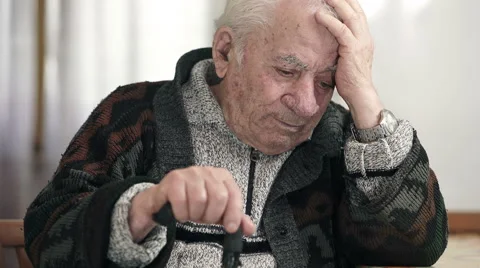 Desperate senior while takes his head with hand and keeps other hand on the cane Stock Footage 63415294