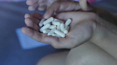 Desperate teen girl attempts to commit suicide with pills. 4K UHD Video stock 64652474