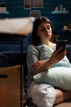 Desperate woman with anxiety problems using mobile phone Stock-Fotos