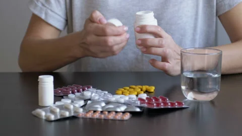 Desperate woman attempts to commit suicide with pills. When provoking suicide Stock Footage 118661761