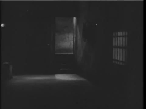 Desperate woman in basement knocking on elevator door to escape, 1930s Stock Footage 58858758