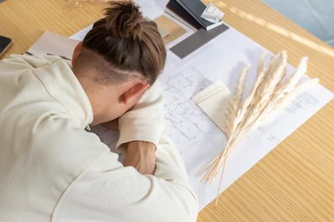 Desperate young architect on the table of work on architectural plans Stock Photos