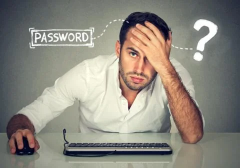 Desperate young man trying to log into his computer forgot password Stock Photos