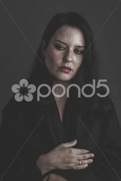 Desperation, sad woman with large black cloth on the body, long-haired brunet Stock Photos