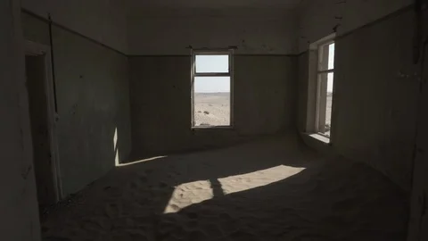 Dessert against sky seen through window of abandoned house - Kolmanskop, Namibia Stock Footage 129075099