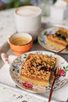 Dessert and coffee for two. nut cake with pieces of pistachios and coffee on  Stock Photos