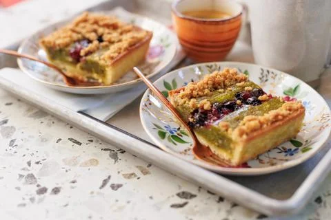 Dessert and coffee for two. nut cake with pieces of pistachios and coffee on  Stock Photos