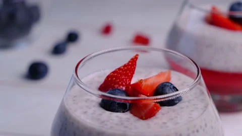 Dessert with berries. Chia seed pudding with berries in a jar on a wooden table Stock Footage 167282663