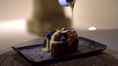 Dessert with berries poured with sauce Stock Footage 261040475