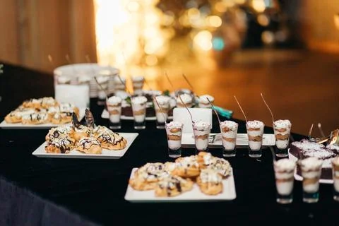 Dessert buffet with trifles and eclairs at a New Year or Christmas party Stock Photos