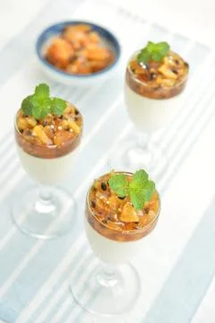 Dessert cake in glasses with mint leaf on white background Stock Photos