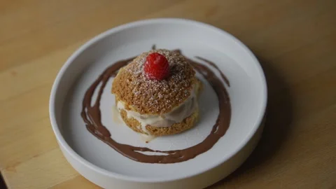 A dessert with a cherry on top is served on a white plate Stock Footage 301518116