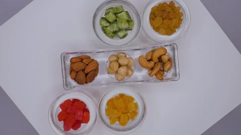Dessert in the form of nuts and candied fruits on a white background Stock Footage 105145571