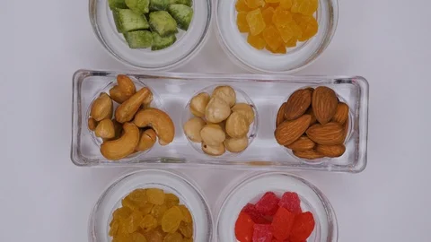 Dessert in the form of nuts and candied fruits on a white background Stock Footage 105280490