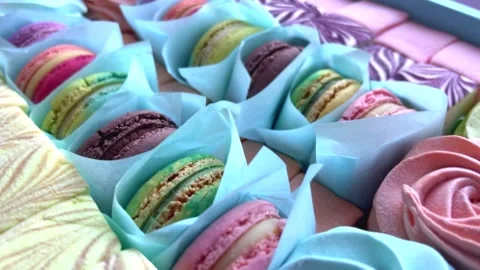 Dessert French Macarons in a present box. Sweet dessert on a pink background. 스톡 동영상 250092911