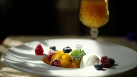 Dessert, mango, berries, and a scoop of ice cream Stock-Footage 163174792