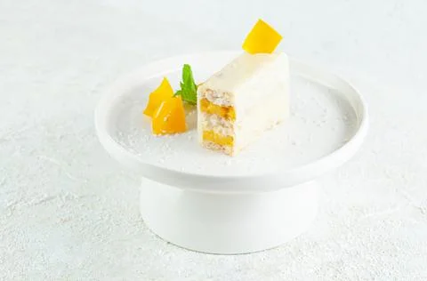 Dessert with mango. Coconut docaz with mango cream and pineapple chunks. Coat Stock Photos