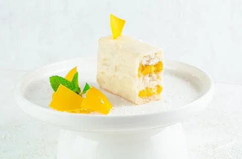 Dessert with mango. Coconut docaz with mango cream and pineapple chunks. Coat Stock Photos