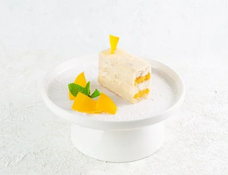 Dessert with mango. Coconut docaz with mango cream and pineapple chunks. Coat Stock Photos