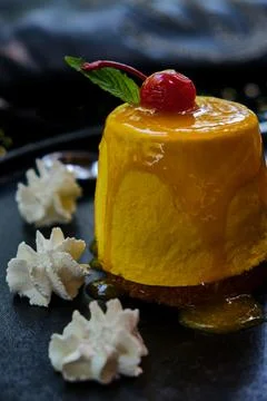 Dessert. Mango passion fruit with cherry and green mint. Stock Photos