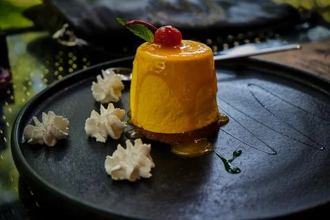 Dessert. Mango passion fruit with cherry and green mint. Stock Photos