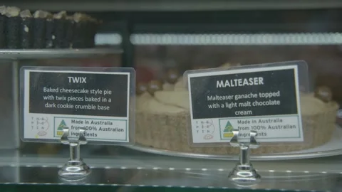 Dessert Pies on Display in Australian Bakery or Cafe Counter with Labels Stock Footage 345669765