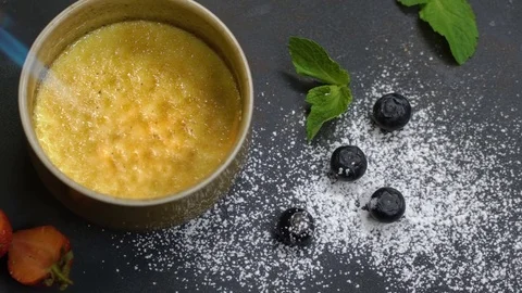 Dessert in a round shape caramelized with a burner. Slow motion Stock Footage 75236331