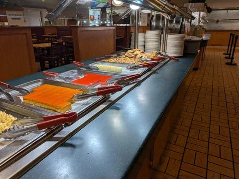 Dessert section of an all-you-can-eat buffet featuring cookies, cakes 스톡 사진