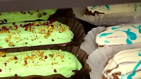 Dessert in the shop window. A culinary masterpiece for sale. Cakes in a coffee Stock Footage 302101260
