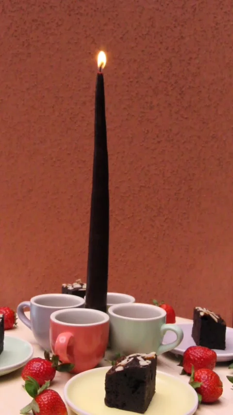 Dessert spinning table candle red wall vertical Video stock 329403291