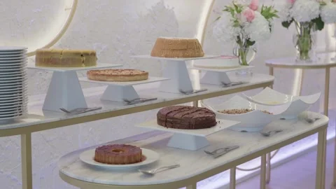Dessert Table With Cakes And Tarts On White Stands At A Wedding Venue Stock Footage 343704326