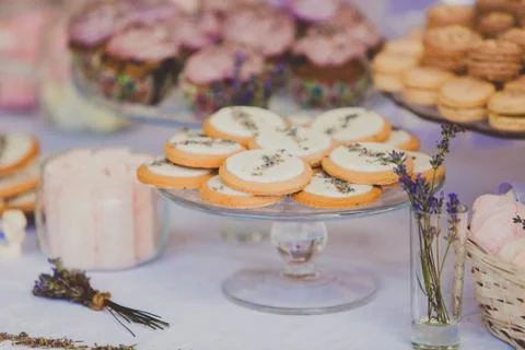 Dessert table for a wedding party. Biscuits decorated with lavanda flowers Stock Photos