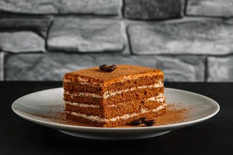 Dessert tiramisu on dark background. Slice of coffee cake Stock Photos