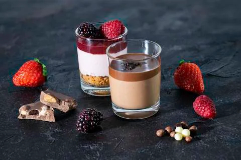 Desserts in crystal glasses. Chocolate with chocolate shavings and strawberry Stock Photos